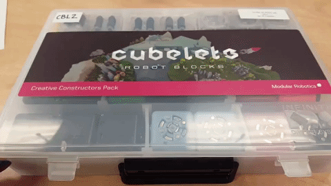 An animated gif of a person opening the Cubelets Creative Constructors Pack.